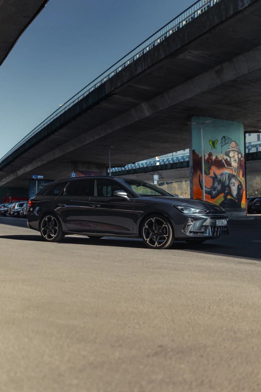 CUPRA Leon Sportstourer w słońcu na tle graffiti